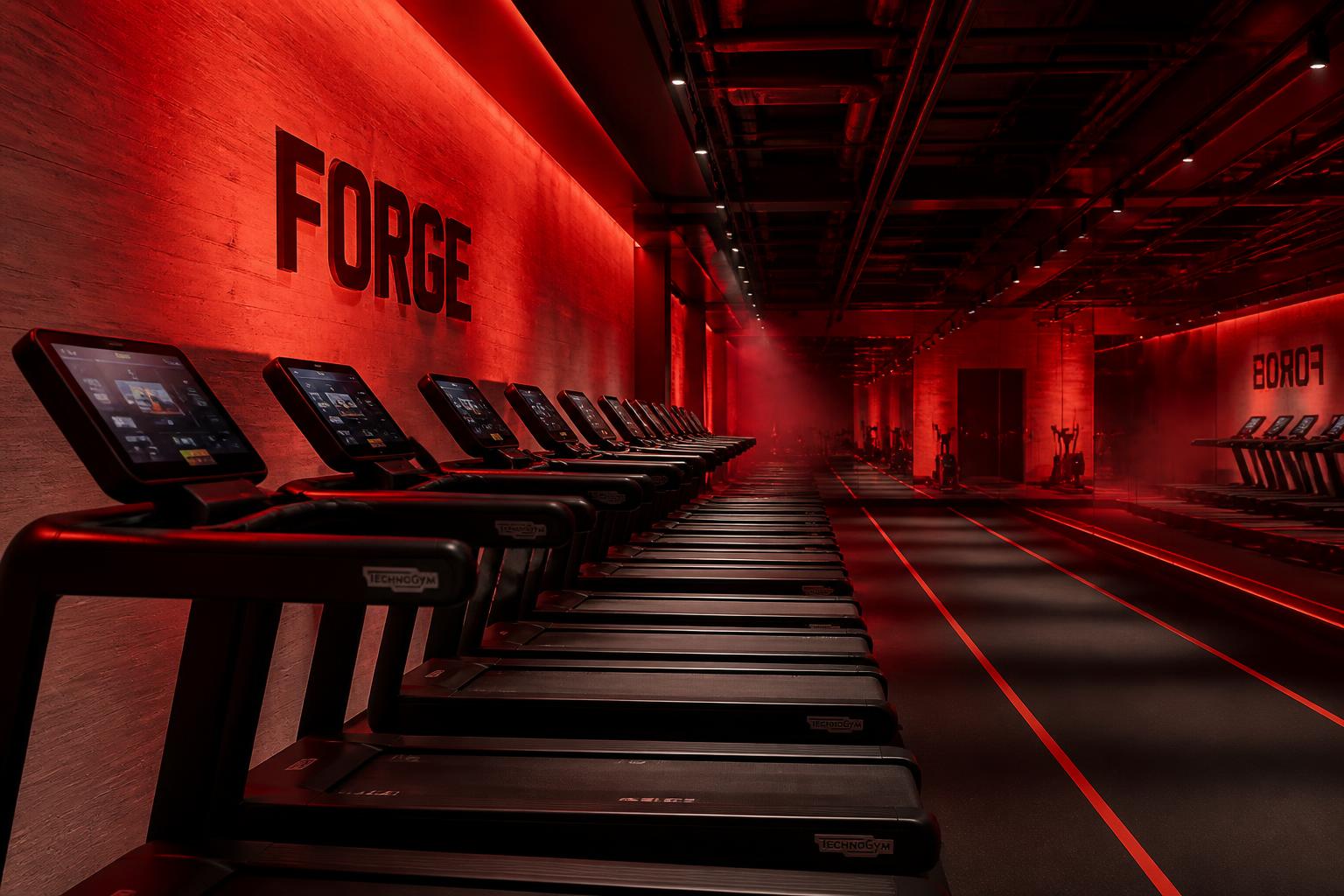 Boutique Fitness Concept — Treadmill aisle — looking to brand wall